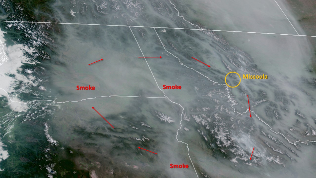 A satellite photo showing wildfire smoke across the northwest with arrows indicating smoke movement in a clockwise direction
