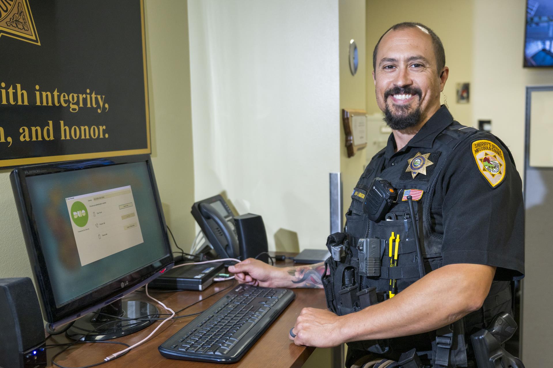 Deputy seated at a computer